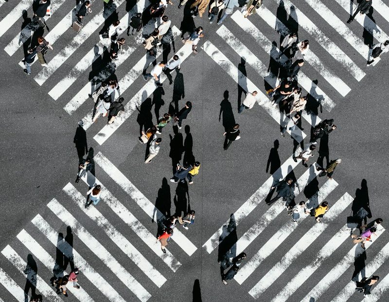 aerial view of people walking on cross pedestrian lane